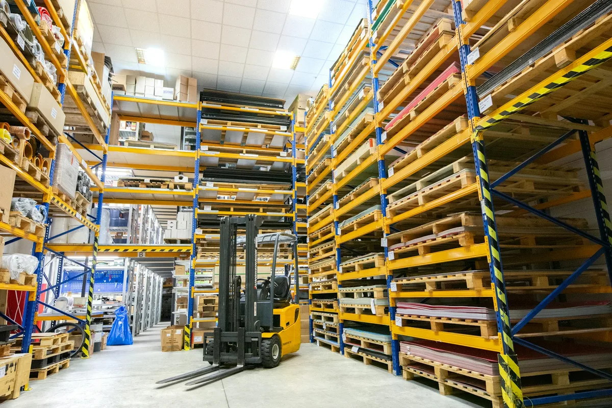 a large warehouse filled with lots of pallets — professional food preparation environment