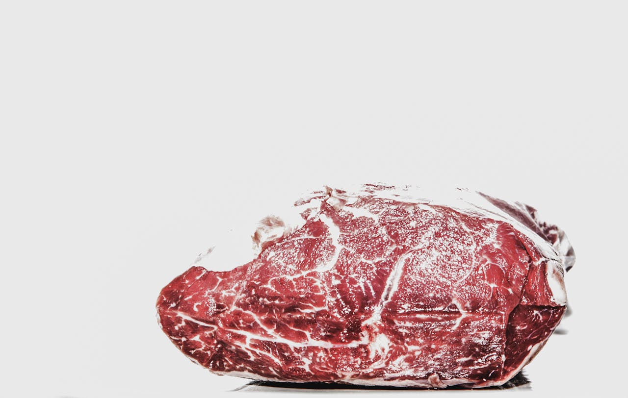 home-hero Premium raw beef piece displayed on a white background, perfect for culinary projects.